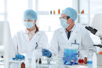 Poster - close up. scientists using a computer in a medical laboratory.