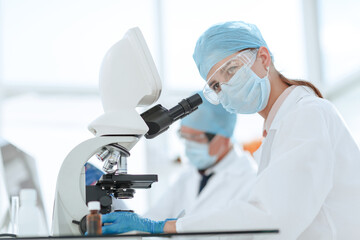 Poster - scientists testing the liquid and writing the results in a laboratory journal.