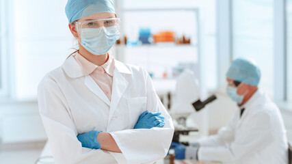 Wall Mural - close up. doctor in a protective mask standing in the laboratory.