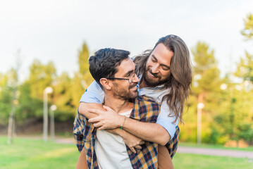 gay male couple having a good time in the park