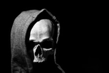 Human Skull In Hood Close Up On Black Background
