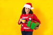 latin christmas middle aged woman with a clay mug of fruit punch on yellow background in mexico latin america
