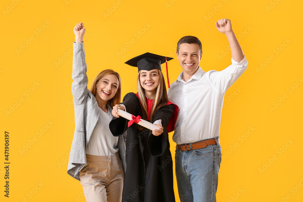 Happy female graduation student with her parents on color background