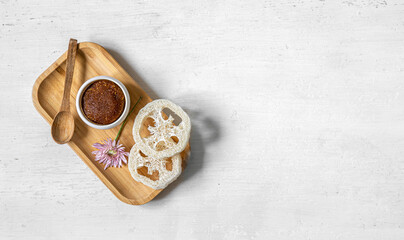 Sticker - Body scrub and other care products on a wooden plate, isolated.