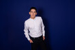 © Denis - Portrait of a handsome student on a purple background. The man is posing for the camera.