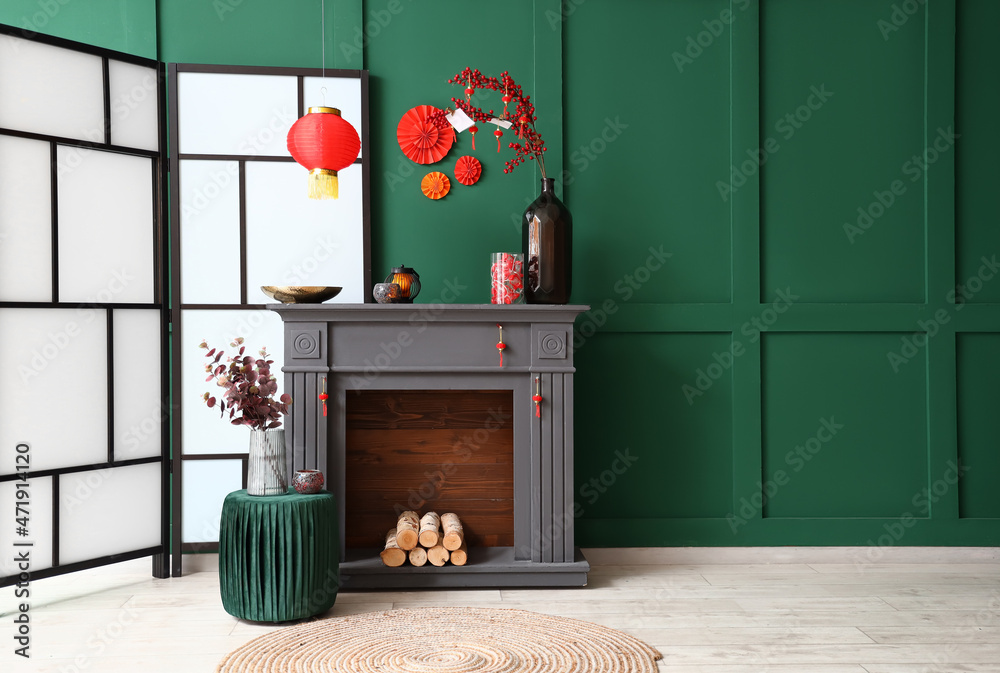 Fireplace with beautiful decorations for Chinese New Year celebration in room