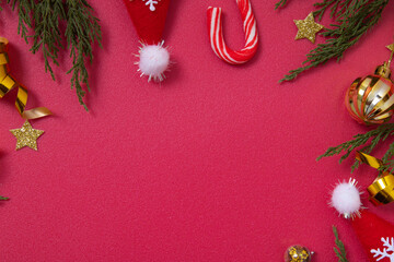 Wall Mural - christmas red background with decorative elements and green branches flat lay copy space