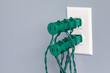 © JJ Gouin - Electrical outlet overloaded with Christmas string lights. Holiday decoration safety, hazards and fire prevention concept.