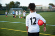UK, Girls soccer team (10-11, 12-13) having training in field