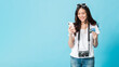 Asian pretty woman tourist preparing for travel and shopping online with smartphone and credit card isolated on blue banner background.Concept of people using technology of travel.