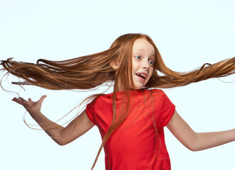 Wall Mural - girl with red hair posing red t-shirt childhood