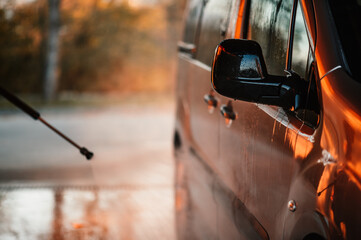 Canvas Print - Manual car wash with white soap, foam on the body. Washing Car Using High Pressure Water.