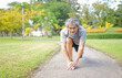 © Verin - portrait an old man with grey hair warming up exercise before running, concept lifestyle, exercise,elderly health care.