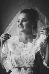 Wall Mural - Perfect fashion woman with beautiful make-up. Bride under the veil in luxury wedding dress. Black and white photo.