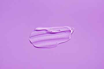 Wall Mural - Cosmetic smear. Appearance of the texture of the transparent gel on purple background. Natural skincare products. Beauty concept for face and body care