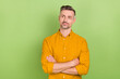 © deagreez - Photo of funny grey hairdo young man crossed palms look empty space wear yellow shirt isolated on green color background