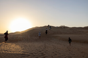 Wall Mural - Sunset in the arabian desert with rolling sand dunes in Abu Dhabi, United Arab Emirates