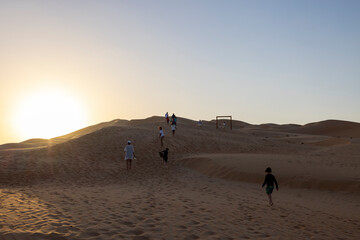 Sunset in the arabian desert with rolling sand dunes in Abu Dhabi, United Arab Emirates
