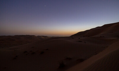 Wall Mural - Sunset in the arabian desert with rolling sand dunes in Abu Dhabi, United Arab Emirates