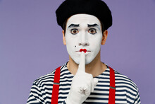 Close Up Secret Vivid Young Mime Man With White Face Mask Wears Striped Shirt Beret Say Hush Be Quiet With Finger On Lips Shhh Gesture Isolated On Plain Pastel Light Violet Background Studio Portrait.