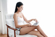 © u photostock - Asia woman sitting on the chair in morning with laptop