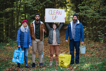 Wall Mural - Diverse group of irritated activists ready to clean up forest, holding banner and looking at camera.