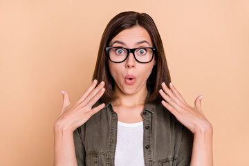 Canvas Print - Photo of surprised funky lady open mouth hands face wear khaki shirt isolated beige color background