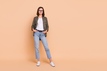 Sticker - Photo of confident successful business lady hands pockets wear specs khaki shirt jeans isolated beige color background