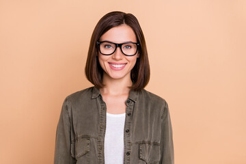 Wall Mural - Photo of positive charming lady shiny toothy smile wear eyewear khaki shirt isolated beige color background