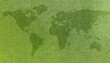 World map on green grass lawn background for global eco-friendly environment, ecological and environmental saving, earth day, and go green backdrop concept