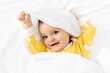 © Lisa Tichané - Happy baby playing peekaboo under white sheet