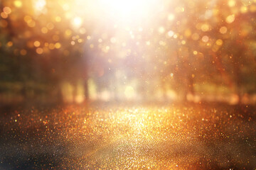 blurred abstract photo of light burst among trees and glitter golden bokeh lights