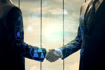 Double exposure of social network theme hologram and handshake of two men.