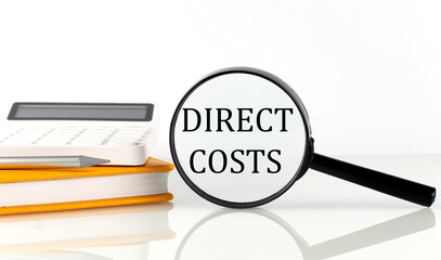 Poster - Magnifier with text DIRECT COSTS with notebook, calculator on white background