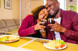 © yurakrasil - african american couple in love drinking wine from glasses and eating italian pasta in living room 14 february valentines day