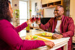 © yurakrasil - african american couple in love drinking wine from glasses and eating italian pasta in living room 14 february valentines day