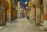 Fototapeta Uliczki - Ferrara - The street of old town at dusk.