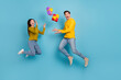 © deagreez - Full length photo of carefree guy lady jump throw gift box present shopping event isolated over blue color background