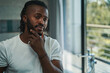 © Viacheslav Yakobchuk - Focused man examining his beard before bathroom mirror