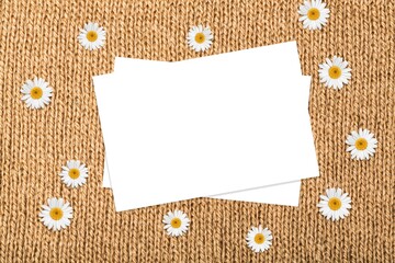 Wall Mural - Flatlay of aesthetic styled invitation template. Blank paper sheet card with chamomile flower