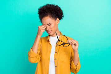 Portrait of attractive tired girl holding specs touching nose suffering isolated over vibrant teal turquoise color background