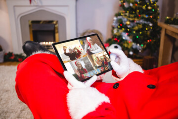 Poster - Santa claus making tablet christmas group video call with family and friends