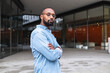 © Westend61 - Man with shaved head standing near buildings