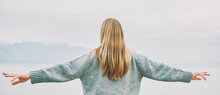 Panoramic Banner Background Back View Of Young Blond Woman With Arms Wide Open Enjoy Landscape Of Cloudy Mountains