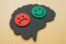 Bipolar Disorder Concept. Brain Shape With Happy And Sad Emoticons.