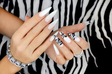 Gel Manicure With Animalistic Pattern And Accessories On The Hands.