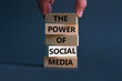 © Dzmitry - Power of social media symbol. Wooden blocks with words The power of social media. Businessman hand. Beautiful grey background, copy space. Business, power of social media concept.