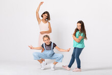 Group Of Cool Girls Fooling Around In White Room, Making Funny Poses