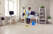 © Studio Romantic - African American woman janitor with mop clean office floor with sanitizer liquid detergent. Black ethnic female housekeeper cleaner wash dirt dust in company workplace. Housekeeping concept.