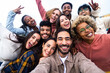 Big group portrait of diverse young people together outdoors - Multiracial happy millennial male and female friends having fun together - Unity and friendship concept - Focus on man in the center